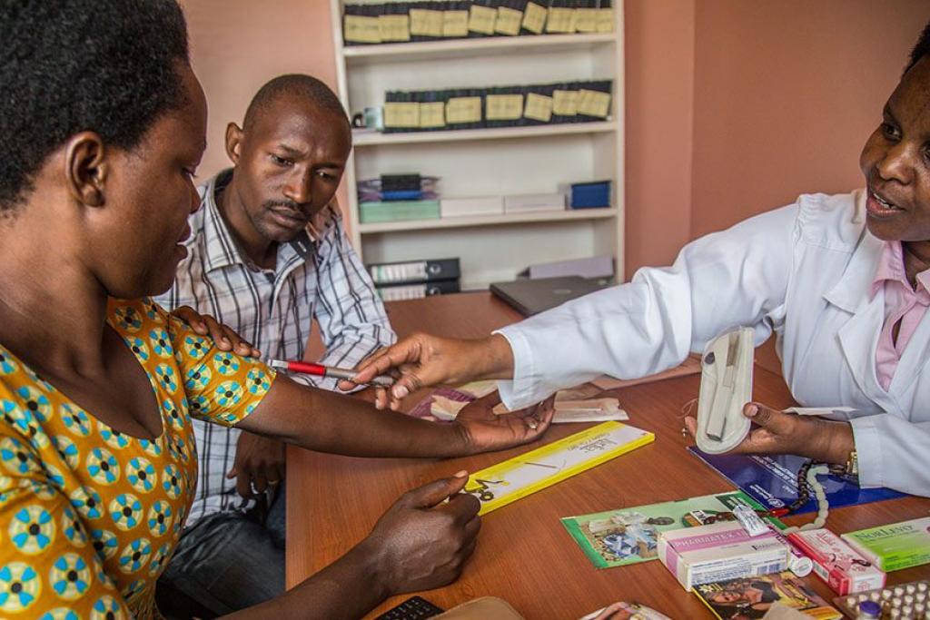 Photo credit: A nurse counsels clients in Rwanda on family planning, sexual and reproductive health and rights, and pregnancy prevention. (Yagazie/EmeziGetty Images/Images of Empowerment)