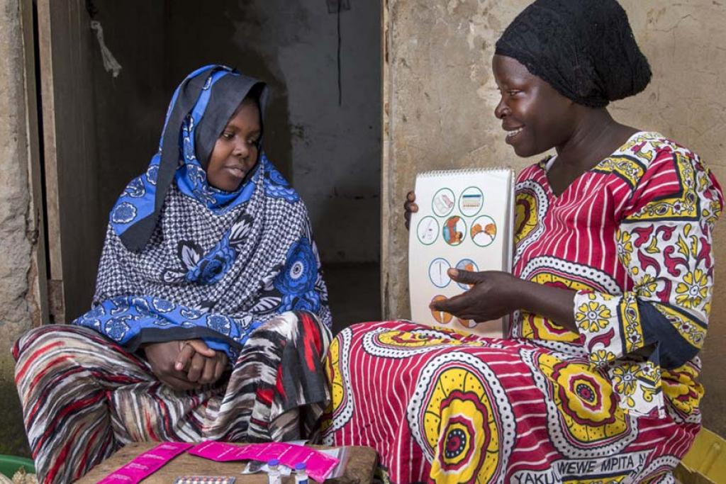 Photo credit: Community health worker during a home visit, providing family planning services and options to women in Uganda. (Jonathan Torgovnik/Getty Images/Images of Empowerment)